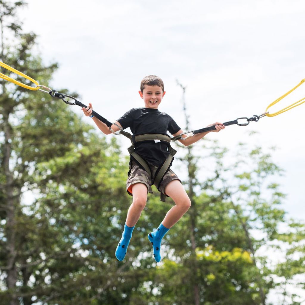 boy bouncing on trampolines at bromley mountain vermonts summer adventure